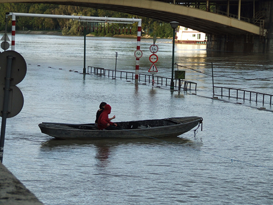 Guy in boat in flood